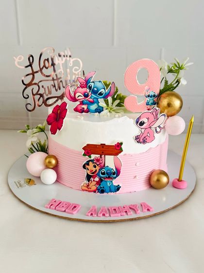 A cute Lilo & Stitch themed cake for a 9th birthday, with tropical flowers and fun character toppers.