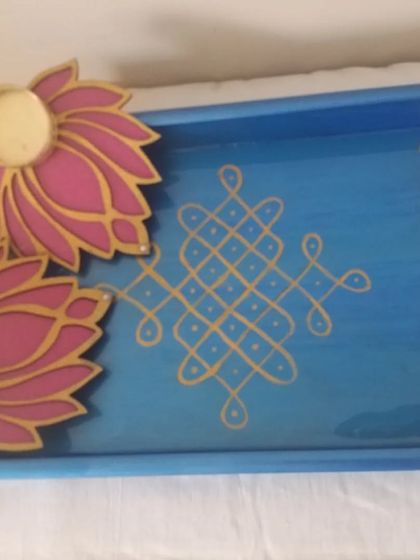 A beautiful festive gift hamper idea. This hand-painted blue tray with a Kolam design is paired with two elegant lotus-shaped T-light holders, creating a perfect Diwali or housewarming gift.