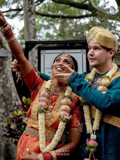 A beautiful moment of shared joy between a cross-cultural couple during their wedding ceremony at our Bangalore venue.