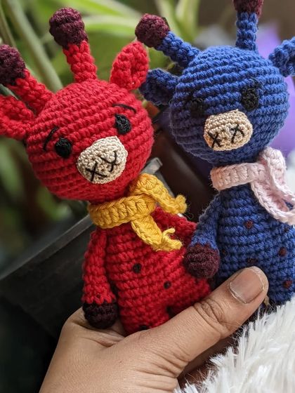 A pair of custom-colored giraffes, one red and one blue.