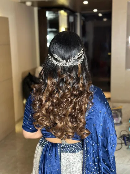 A close-up of the back, showing the unique hair accessory and the texture of the curls. This is a great look for a cocktail party.