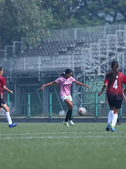 A player controlling a high ball, showing excellent technique and composure.