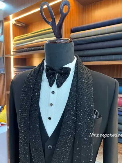 This tuxedo, inspired by celebrity red carpet looks, features a three-piece construction with a fully embellished scarf-lapel.