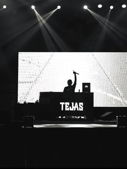 A silhouette of me on stage in Patna, with my name lit up on the DJ console.
