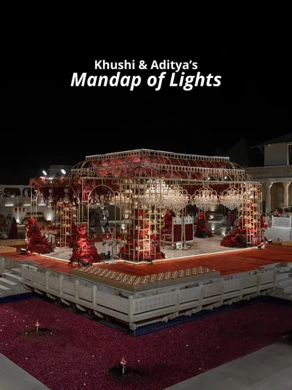 We named this Khushi and Aditya's 'Mandap of Lights'. The intricate gold structure, set over a pool of floating petals and illuminated by countless candles, created a breathtaking and unforgettable backdrop for their vows.