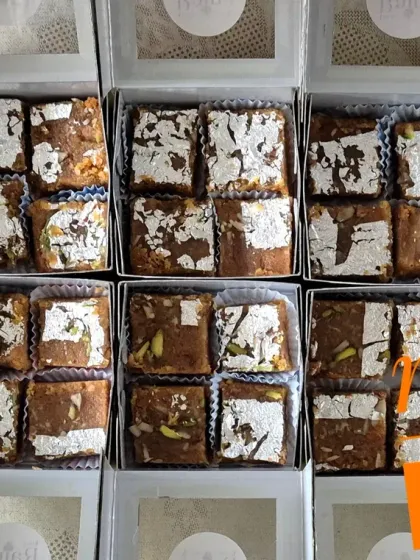 A large order of Moong Daal Barfi packed in individual window boxes for gifting.