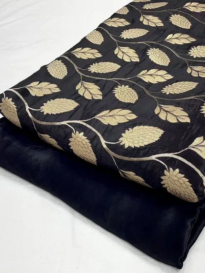 A classic black designer crepe jacquard fabric with golden leaf motifs.