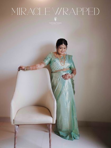 A full-length portrait of the mother-to-be standing next to a chair, with the words "Miracle Wrapped" overlaid. This simple, modern shot beautifully celebrates the wonder of pregnancy.