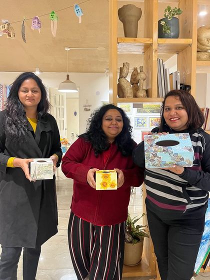 These participants are happy with the personalized tissue boxes they designed and painted in one of our functional art workshops.