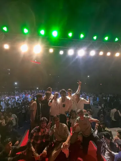 The whole crew on stage, celebrating with a massive crowd behind us. College fests are always memorable.