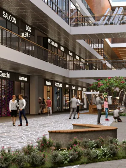 An interior plaza within a retail hub, designed to encourage pause and interaction. Benches and landscaping turn a simple circulation space into a place where people can gather and connect.