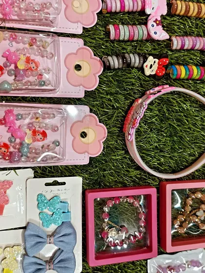 This photo shows a collection of my jewelry and hair accessories. You can see beaded bracelet sets, hair clips, and character themed hair ties, all great for Kanjak or birthday return gifts.