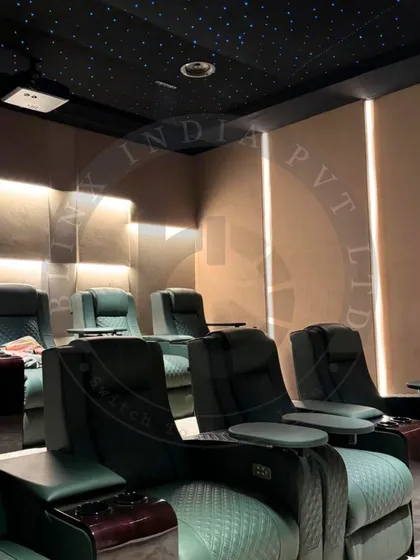 In this Amritsar home theater, we combined luxurious green recliners with textured 3D wall panels and soft backlighting. The fiber optic star ceiling adds a touch of magic, creating a private celestial escape for watching films.
