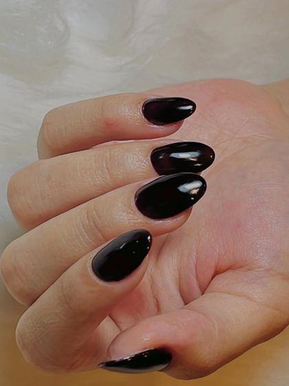 A different view of these stunning deep black cherry nails. The high-gloss finish reflects the light beautifully, showing off the rich color.