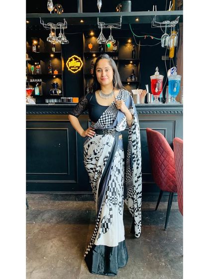 A full-length shot of my black and white printed saree. I love how a statement belt can give a traditional saree a modern and structured silhouette.