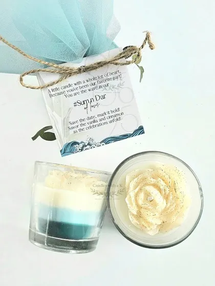 Gifts that Tell a Story. A close-up of a Save-The-Date gift created for a couple's ocean-themed wedding. This layered votive candle, with its custom tag and beautiful packaging, shows how every detail is tailored to bring your vision to life.