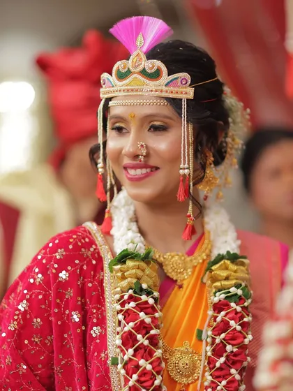 A close-up of the bride's joyful expression. Her makeup is soft and pretty, with a focus on enhancing her smile and the sparkle in her eyes.