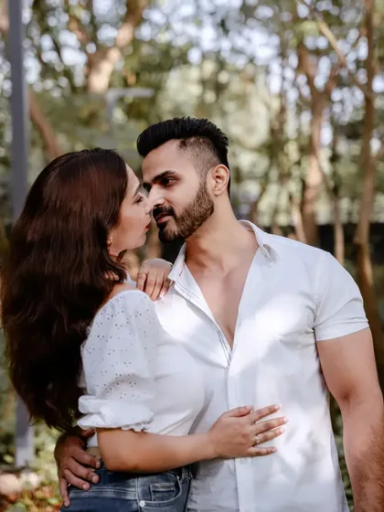 An intimate and romantic close-up of a couple in a lush green park, perfect for a pre-wedding couple photoshoot.