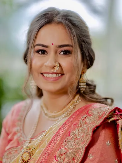 A close-up that shows the delicate bindi and the classic Maharashtrian nath. The makeup is kept clean and fresh to let these traditional details shine.