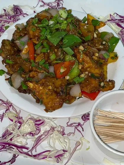 A platter of delicious chili paneer, a spicy and tangy vegetarian starter that is always a hit.