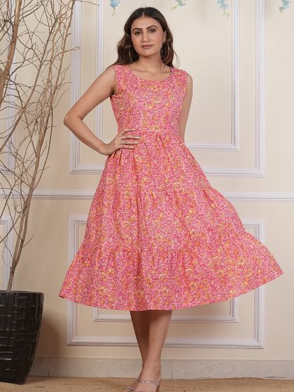 This sleeveless tiered dress in a vibrant pink floral print is a customer favorite. It has a flattering fit and a tiered skirt that adds a playful, flowy movement.