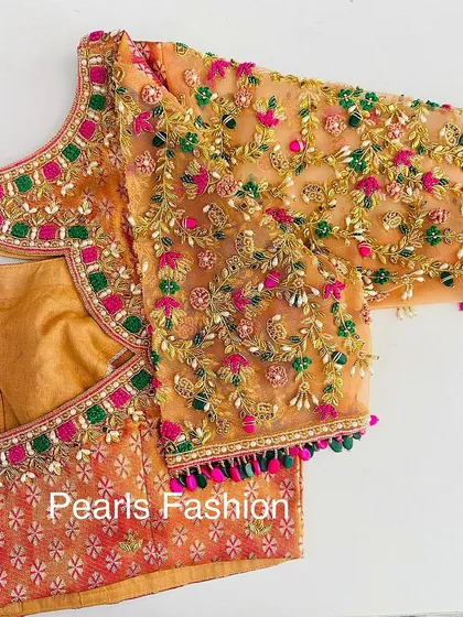 I work with delicate fabrics like net to create detailed designs. This blouse features multi-color threadwork, Zari, and bead embroidery on the net sleeves, with a matching heavy border on the neckline.