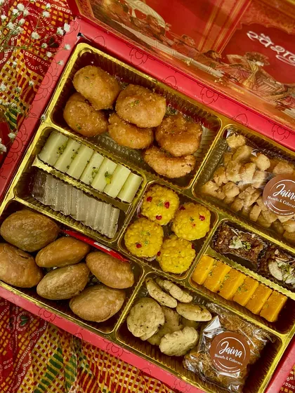 I love customizing these boxes to fit your taste. This assortment includes a mix of dry fruit sweets, baked mathi, and traditional barfis, ensuring every bite is a delight.