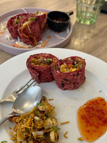 A delicious and healthy brunch platter featuring beetroot rolls and a side of bhel. This is a great example of the creative and tasty food I offer.
