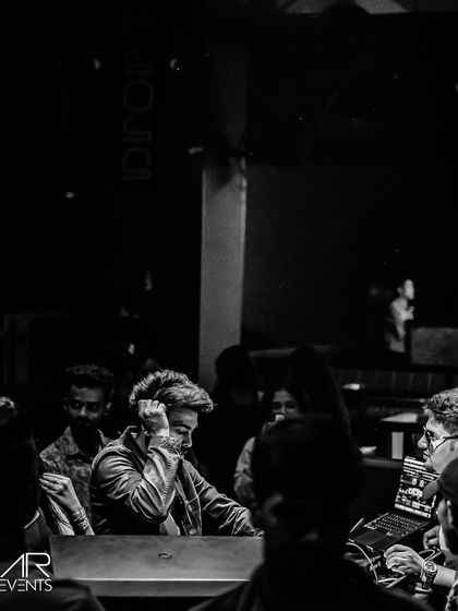 A moody black and white shot of me listening intently on my headphones, preparing the next track.