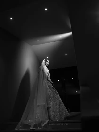A black and white version of the staircase portrait, creating a high-contrast, cinematic image.