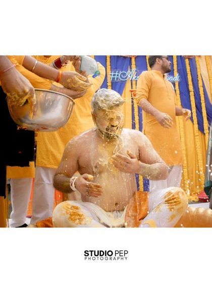 A classic Haldi moment, with the groom, Akshat, getting completely covered in turmeric paste by his loved ones.