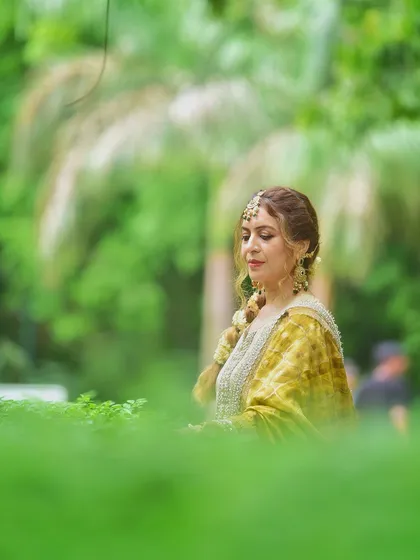 A serene, eyes-closed portrait framed by green leaves. This shot creates a peaceful and meditative mood, focusing on the subject's calm demeanor.