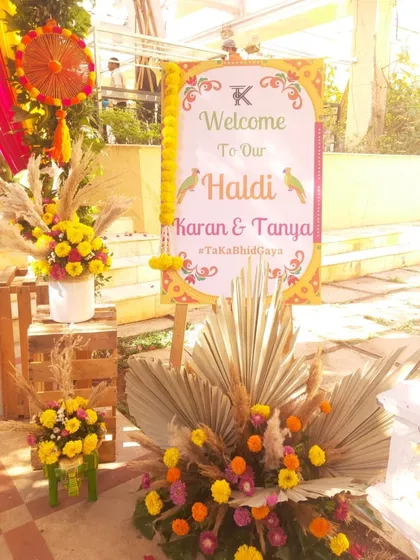 A personalized welcome sign for Karan and Tanya's Haldi. The custom hashtag and parrot motifs add a unique and personal touch to the decor.