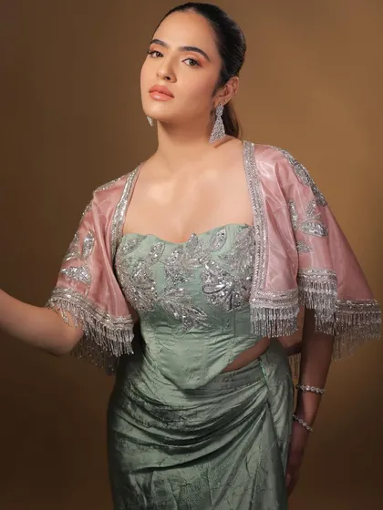 Adding a sheer pink jacket to the look adds a touch of softness and romance. The makeup is versatile enough to work with multiple styling options.