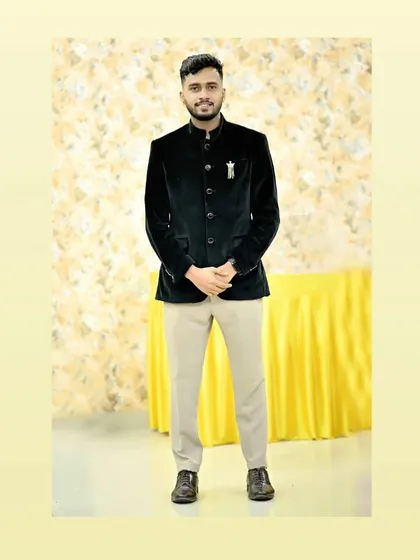 A client wearing our black velvet Jodhpuri jacket. This is a great rental piece for a formal dinner or a wedding reception, offering a touch of luxury.