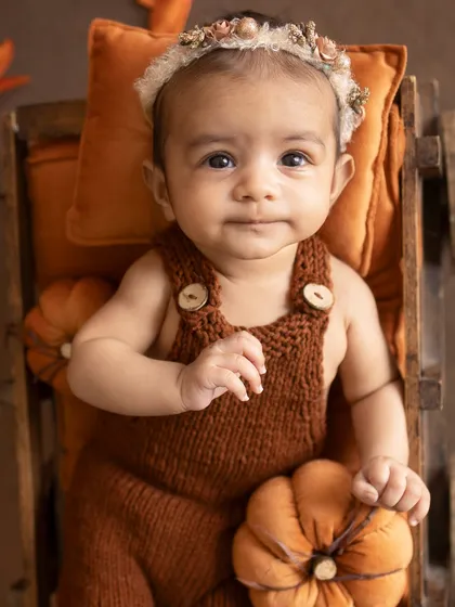 A calm and observant portrait of the 3-month-old.