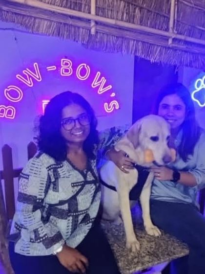 Posing in front of our neon sign. Our cafe provides a great backdrop for memorable photos with your furry friend.