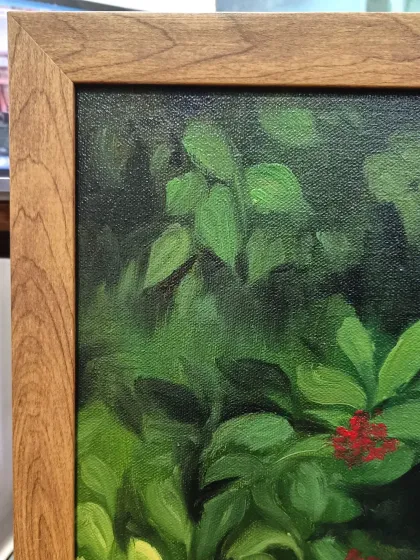 A detail shot of the custom wooden frame and the texture of the canvas.