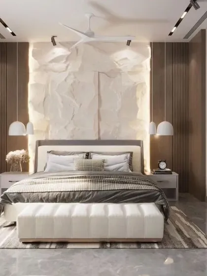 This luxury bedroom is a study in texture and light. A unique, crumpled-paper-effect feature wall is backlit to create a soft glow, while a large abstract artwork adds a bold, modern statement. The result is a classy and artistic personal space.