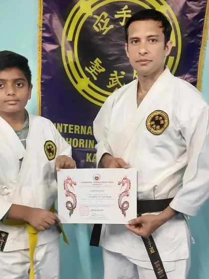 I congratulate a young student on successfully passing his Kyu grading. Advancement is a direct result of dedication and hard work, and I formally recognize every student's progress with certified ranking.