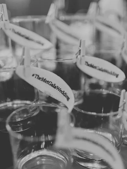 A small but significant detail: custom drink tags with the wedding's hashtag, #TheMetGalaWedding, ensuring the theme was present in every element.