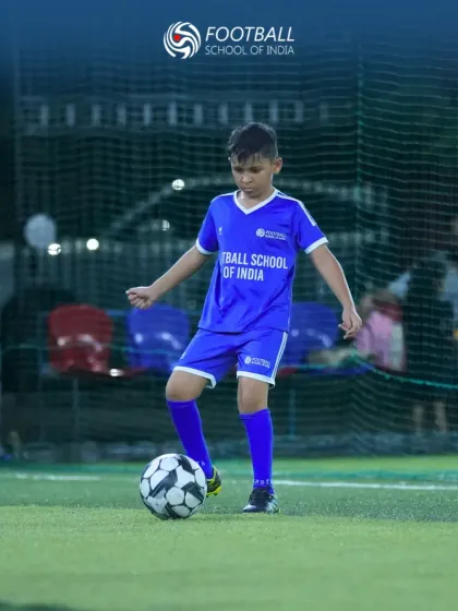 Confidence on the ball is built through consistent practice. This young player demonstrates focus and proper technique as he prepares to make his next move during a training session at our football academy.
