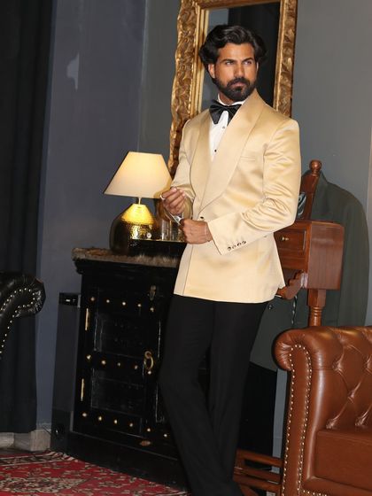 The ivory shawl lapel tuxedo is a timeless choice for any formal event. Its light color and sharp tailoring create a look of pure sophistication.