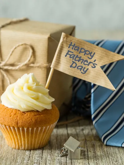 A single cupcake with a "Happy Father's Day" flag, perfect for a small, personal celebration. This vanilla cupcake with buttercream frosting is a sweet and simple gesture to show your appreciation for dad.