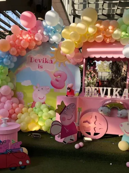 Bringing the cheerful world of Peppa Pig to life for a memorable 3rd birthday. This vibrant setup includes a custom backdrop, a rainbow balloon arch, and character cutouts, all designed to create an immersive and fun experience for the little ones.