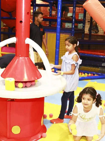 Kids interacting with the ball volcano, one of the many activities included in our all-day play packages.