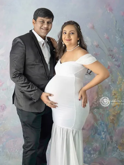 A proud and happy couple portrait. His hand on her bump is a classic gesture that beautifully symbolizes their shared journey into parenthood.