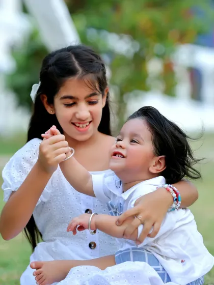 The pure joy of sibling love captured in an outdoor setting. We encourage playful interactions to get the most natural and heartwarming shots.