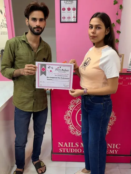 This student is officially a certified nail professional. It's always rewarding to hand over the certificate they've worked so hard for.