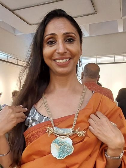 This stunning client is wearing one of my bold, sculptural necklaces. I love creating statement jewellery that is both artistic and wearable.